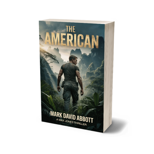 Book titled 'The American' by Mark David Abbott with a jungle scene on the cover.